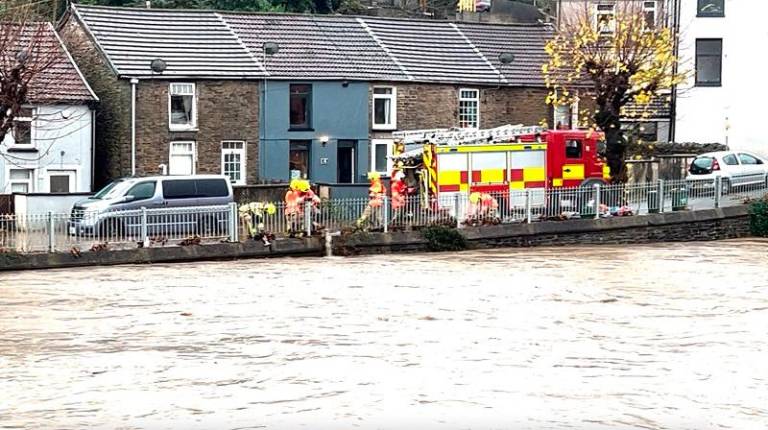 Firefighters let water into a swollen river as Storm Bert batters Britain, in Pontypridd, Wales, Britain, November 24, 2024, in this picture obtained from a social media video. - Kate Strong/via REUTERS