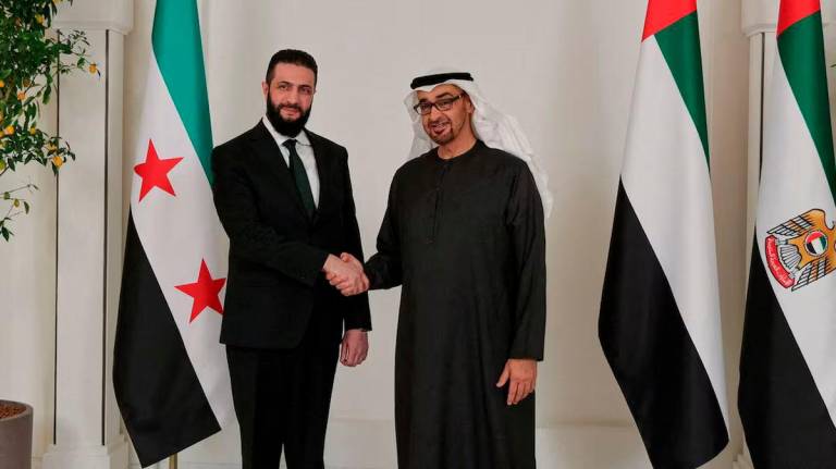 Syrian President Ahmed al-Sharaa shakes hands with UAE’s President Sheikh Mohamed bin Zayed Al Nahyan, in Abu Dhabi - REUTERSpix