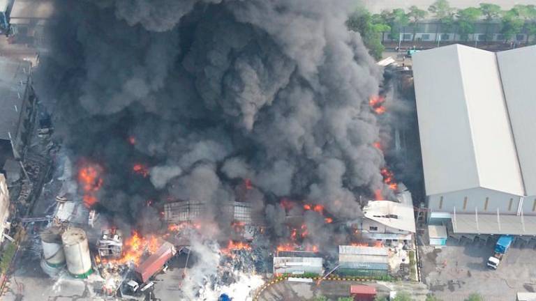 A drone view shows smoke and flames rising at a cooking oil factory, in Bekasi, West Java province, Indonesia November 1, 2024, in this screen grab obtained from a social media video. - ILHAM APRIYANTO/via REUTERS