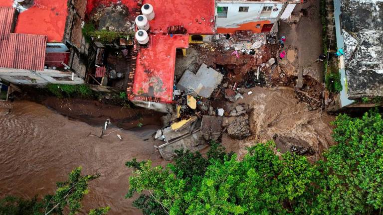 A drone view shows an overflowing river as torrential rains from tropical storm Raymond triggered landslides and flooding in Jalcocotan, Nayarit state, Mexico October 12, 2025. - REUTERSPIX