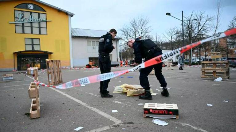 French municipal Police officers work to collect evidence at the site of a bladed weapon attack where a man is suspected of killing one person and wounding several municipal police officers in Mulhouse - AFPpix