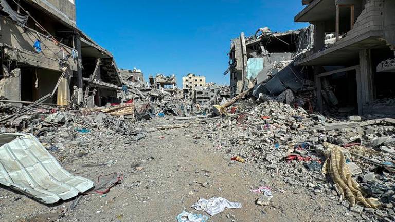 Palestinians view the damage after Israeli forces withdrew from the area around Kamal Adwan hospital, amid the ongoing Israel-Hamas conflict, in Jabalia, in the northern Gaza Strip October 26, 2024. - REUTERS/Stringer