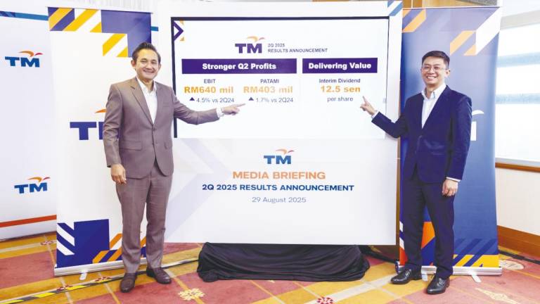 Amar Huzaimi (left) and group chief financial officer Ahmad Fairus Rahim at TM’s results briefing in Kuala Lumpur on Friday.