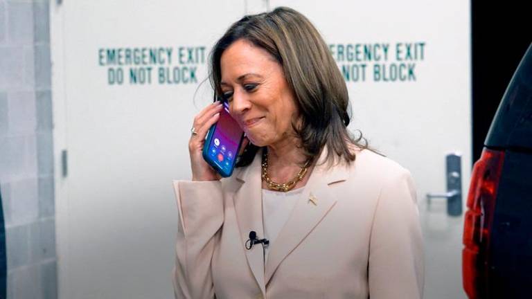 U.S. Vice President Kamala Harris speaks on the phone with former President Barack Obama and former first lady Michelle Obama as the Obamas endorse Harris as the Democratic presidential candidate in this still image taken from a video released on July 26, 2024. Harris for President campaign/Handout via REUTERS