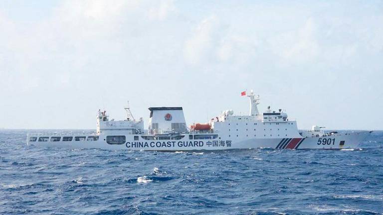 This handout photo taken on January 11, 2025 and released on January 12 by the Philippine Coast Guard (PCG) shows a Chinese Coast Guard ship sailing some 60 nautical miles (111 kilometres, 69 miles) west of the main Philippine island of Luzon while being monitored by Philipine Coast Guard ship BRP Teresa Magbanua (not pictured). The Philippines on January 12 accused China of pushing its patrol ships close to the main Filipino landmass as part of Beijing’s alleged illegal grab of most of the South China Sea. - AFP PHOTO / PHILIPPINE COAST GUARD (PCG)