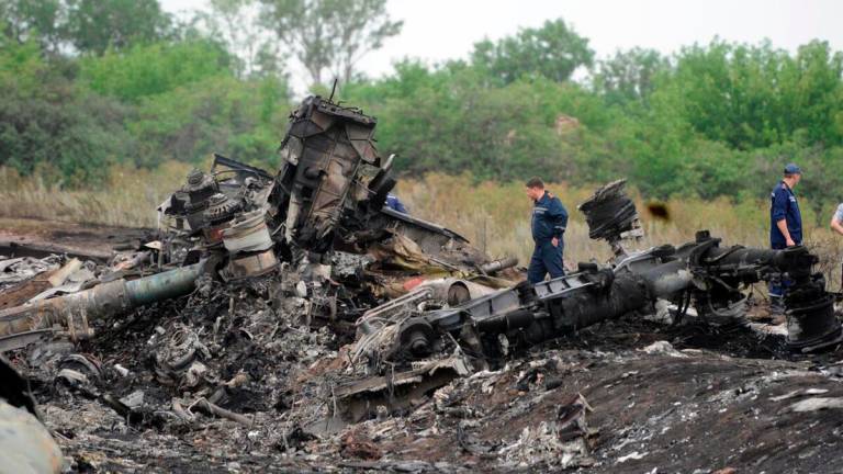Rescuers stand on July 18, 2014 on the site of the crash of a Malaysian airliner carrying 298 people from Amsterdam to Kuala Lumpur, near the town of Shaktarsk, in rebel-held eastern Ukraine. -AFP