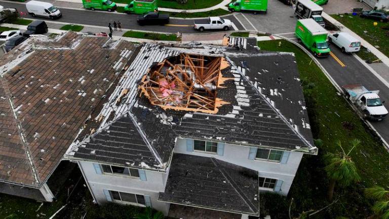 A drone view shows a house with its roof damaged by a tornado in a zone affected by Hurricane Milton, in Palm Beach Gardens, Florida. REUTERSPIX