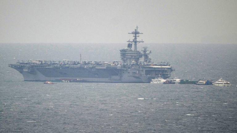 A general view of US aircraft carrier USS George Washington (CVN-73) shortly after berthing at Manila Bay in Manila on July 3, 2025. (Photo by Ted ALJIBE / AFP)
