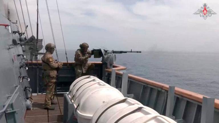 Service members are seen onboard a Russian warship during joint naval exercises, which are held to practice tasks including artillery fire and also involve China and Iran, in the Gulf of Oman, in this still image taken from video released March 12, 2025. REUTERSpix