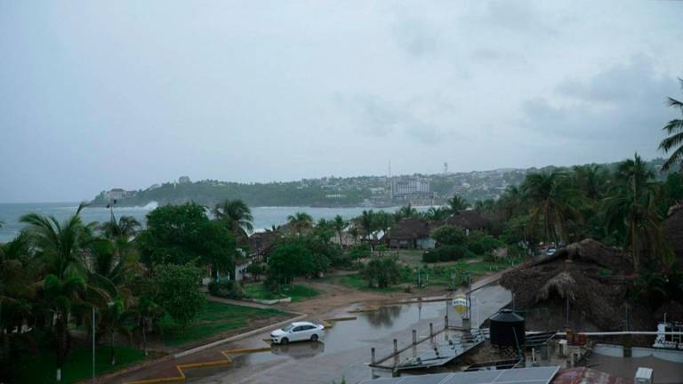 This frame grab from AFPTV video footage shows the popular tourist town of Puerto Escondido as Hurricane Erick approaches Mexico's Pacific coast as a powerful Category 3 storm in Oaxaca state, Mexico on June 18, 2025. - Carlo ECHEGOYEN / AFPTV / AFP