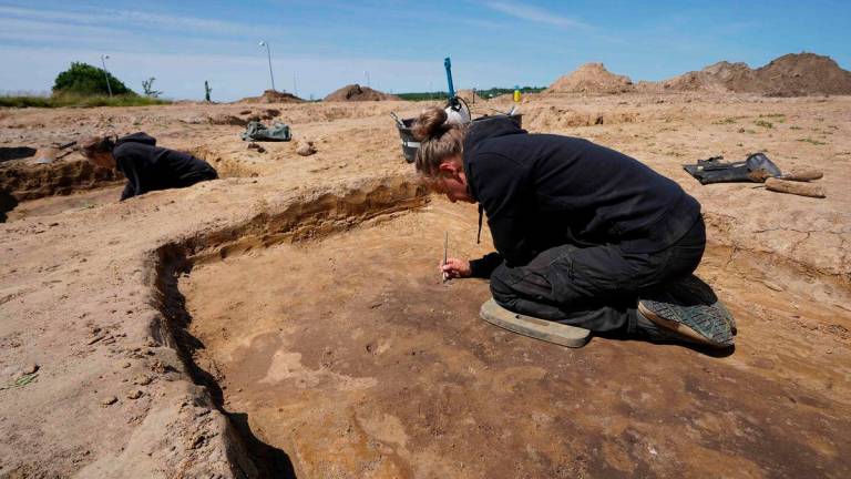 An archaeologist works at a Viking Age burial site in Lisbjerg, a village seven kilometres north of Aarhus, Denmark’s second largest city, on June 13, 2025. (Photo by James Brooks / AFP)