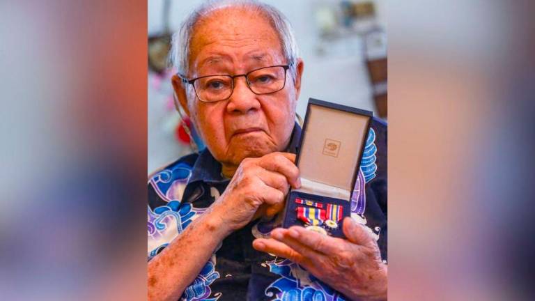Woon showing the medals he received during the Covid-19 lockdown. – ADAM AMIR HAMZAH/THESUN