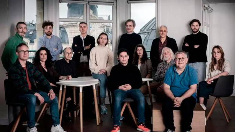 The team behind the Charlie Hebdo satirical newspaper pose during a photo session in Paris in March 2024. © Joel Saget, AFP