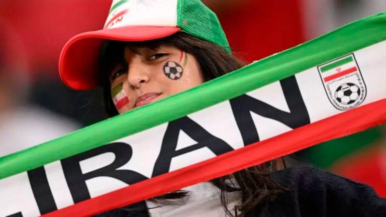 An Iran fan supports her team at a game against the US side at the Qatar 2022 World Cup © Fabrice COFFRINI / AFP