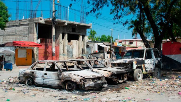 Charred vehicles remain parked as gang violence escalates in Port-au-Prince, Haiti, on March 9, 2024. © Clarens Siffroy, AFP