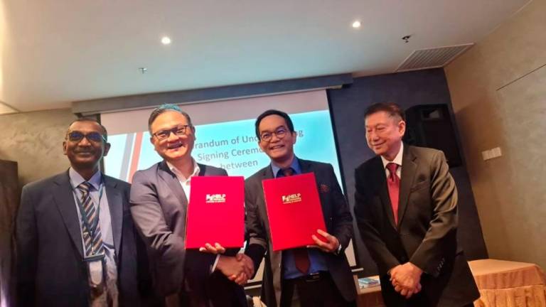 FROM left, Prof Ravichandran, Dr Tham, Prof Liew and Dr Chan, plan for the new alliance to forge new frontiers in biotechnology and create a new breed of healthcare professionals