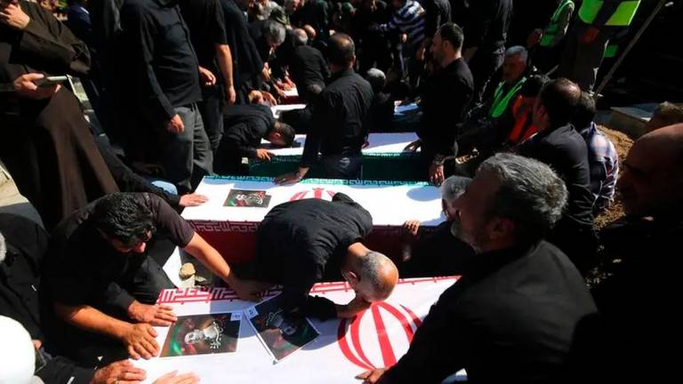 Mourners gather around the coffins of people killed in Israeli attacks in Khorramabad during their funeral in the city in central western Iran on June 16, 2025. (Photo by AFP)