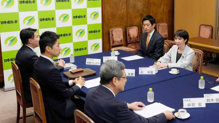 Leader of Japan’s ruling Liberal Democratic Party (LDP) Sanae Takaichi and Policy Chief Takayuki Kobayashi meet Japan Innovation Party’s Policy Chief Alex Saito, co-leader Fumitake Fujita and Secretary-General Hiroshi Nakatsuka at Japan’s National Diet Building in Tokyo, Japan, in this photo taken by Kyodo October 16, 2025. - Kyodo/via REUTERS