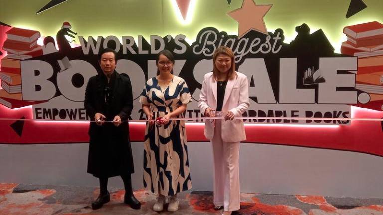 Selangor state assemblyperson Michelle Ng Mei Sze (centre) opens the Big Bad Wolf Books’ 24-hour sale. With her are co-founders Andrew Yap (left) and Jacqueline Ng.