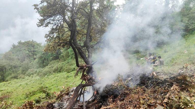 This handout photograph taken on June 15, 2025 and released by the State Disaster Response Force (SDRF) of India’s Uttarakhand state shows smoke billowing from the site of a chopper crash near Gaurikund. Seven people including a toddler were killed on June 15, in India when a helicopter ferrying Hindu pilgrims back from a shrine crashed in the Himalayas, officials said. AFPpix