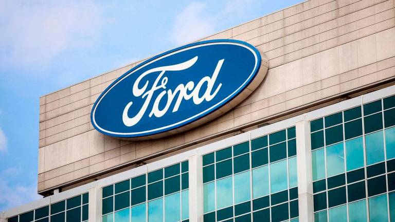 FILE PHOTO: A Ford logo is seen on the Ford Motor World headquarters in Dearborn, Michigan, U.S., March 12, 2025. REUTERS/Rebecca Cook/File Photo/File Photo