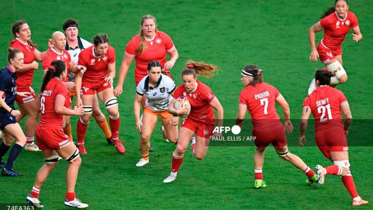 Canada's centre Alex Tessier (C) runs with the ball during the Women’s Rugby World Cup quarter-final between Canada and Australia at Ashton Gate Stadium, Bristol, southwest England, on September 13, 2025. - AFP