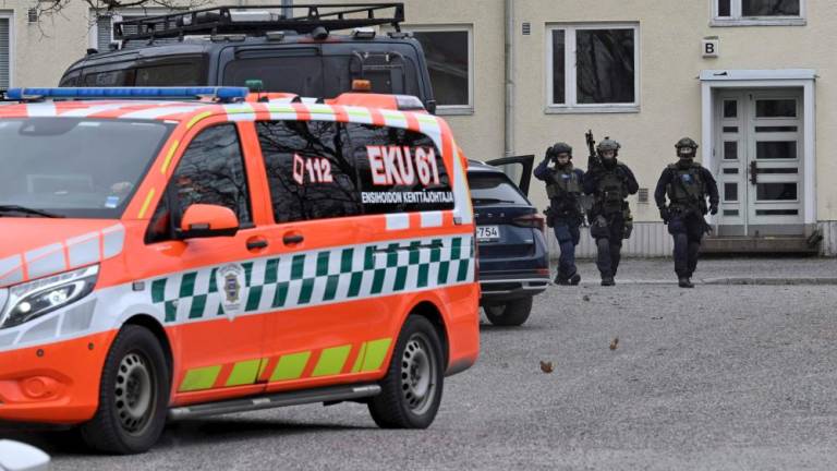 Finnish police officers, police vehicles and an ambulance are seen at the primary Viertola comprehensive school where a child opened fire and injured three other children, on April 2, 2024 in Vantaa, outside the Finnish capital Helsinki/AFPPix