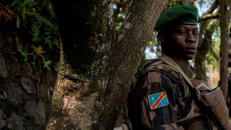 FILE PHOTO: A Congolese soldier stands guard as he waits for the ceremony to repatriate the two bodies of South African soldiers killed in the ongoing war between M23 rebels and the Congolese army in Goma, North Kivu province of the Democratic Republic of Congo February 20, 2024. REUTERSpix