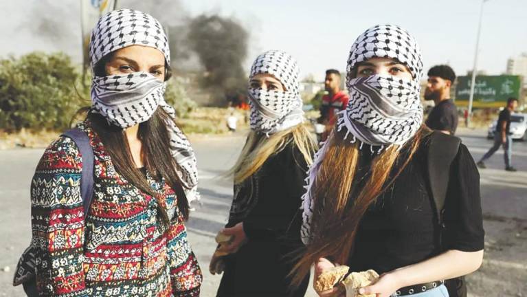 Keffiyeh can also be worn similar to a ‘tactical shemagh’ for anonymity. - AFPPIC