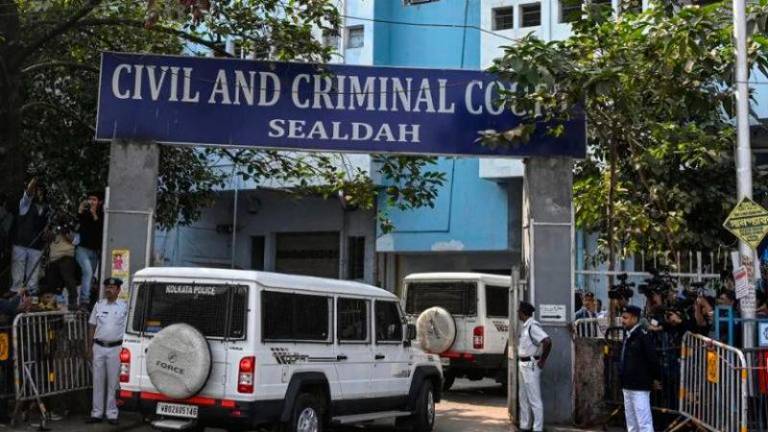 Police personnel stand guard at the entrance of the Civil and Criminal Court Sealdah in Kolkata - AFPpix