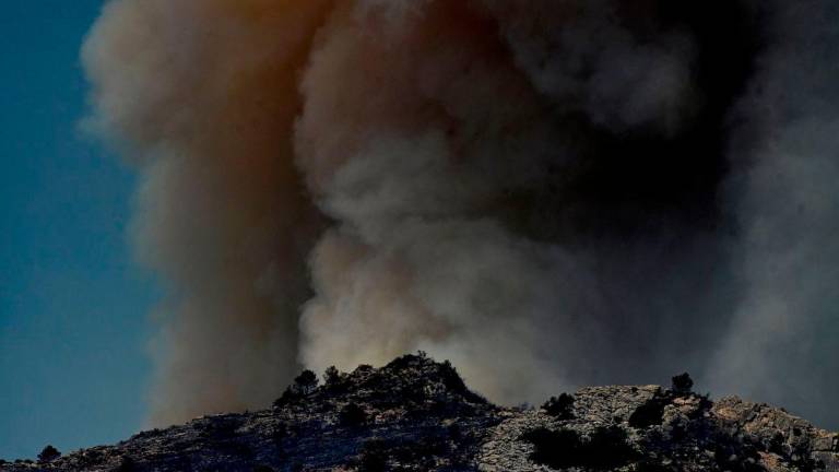 Smoke billowing from a forest fire near Pauls, next to Tarragona, in Spain’s Catalonia region. (Photo by JOSE JORDAN / AFP)