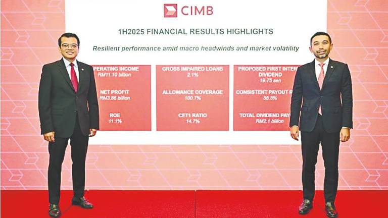 Novan (right) and chief financial and strategy officer Khairul Rifaie at CIMB Group’s first-half financial results press conference today.