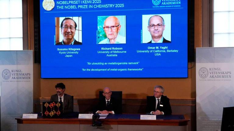 A screen displays the 2025 Nobel Prize laureates in Chemistry, Susumu Kitagawa (Kyoto University, Japan), Richard Robson (University of Melbourne, Australia), and Omar M. Yaghi (University of California, Berkeley, U.S.), as they are announced during a press conference at the Royal Swedish Academy of Sciences in Stockholm, Sweden October 8, 2025. REUTERS/Tom Little