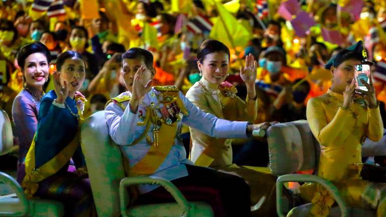 Thailand’s King Maha Vajiralongkorn (C) talks to Princess Bajrakitiyabha Mahidol (2nd L) as they sit with Queen Suthida (2nd R), Princess Sirivannavari Nariratana (R) and royal noble consort Sineenat Bilaskalayani (L), also known as Sineenat Wongvajirapakdi, in a golf buggy during a ceremony to commemorate the birthday of the late Thai king Bhumibol Adulyadej at Sanam Luang in Bangkok on December 5, 2020. AFPPix