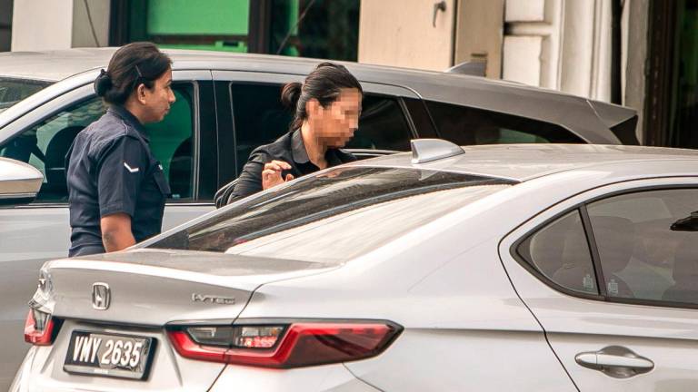 The woman being taken to be remanded in Ipoh yesterday. – BERNAMAPIC