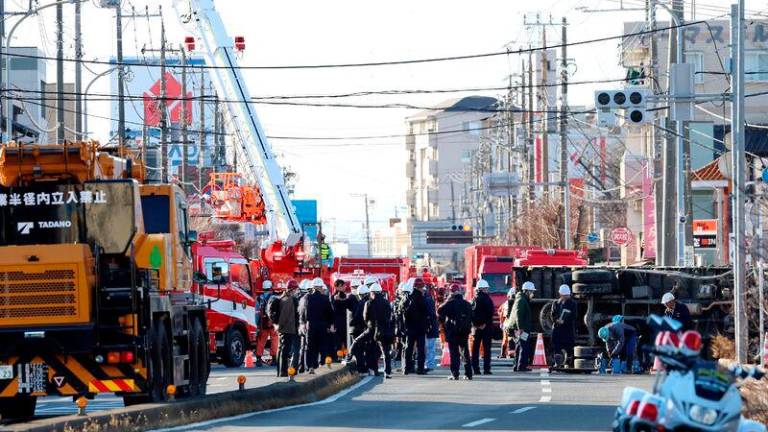 Rescue operations continue for a truck driver after his vehicle was swallowed up by a sinkhole at a prefectural road intersection the day before, in the city of Yashio, Saitama Prefecture on January 29, 2025. AFPpix