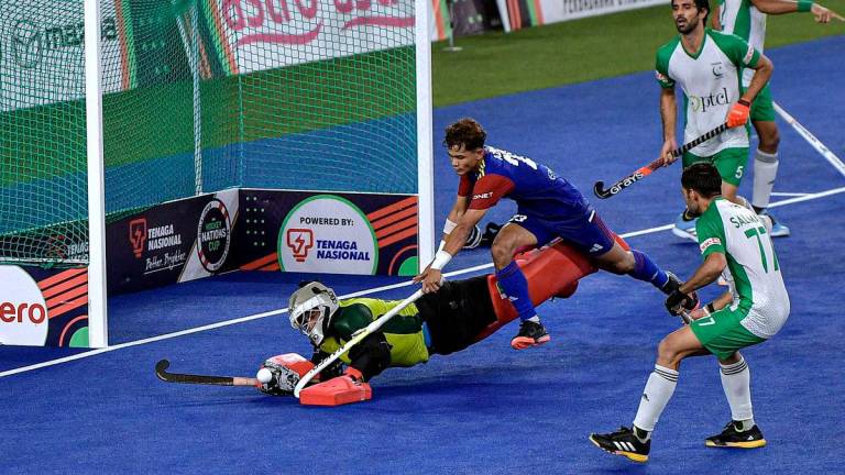Pemain pasukan Malaysia Abu Kamal Azrai cuba merampas bola daripada asakan penjaga gawang pasukan Pakistan Abdullah Ishtiaq Khan (kiri) pada perlawanan peringkat kumpulan B Kejohanan FIH Hoki Piala Negara-Negara 2024-25 di Stadium Nasional Hoki Bukit Jalil hari ini.