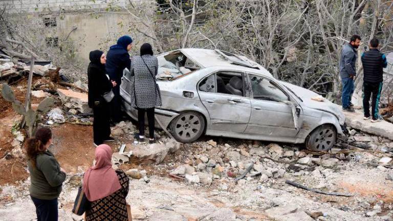 People gather at the site of an Israeli airstrike on the northern Lebanese town of Ain Yaaqoub - REUTERSpix