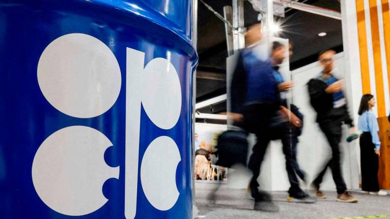 FILE PHOTO: People walk past an installation depicting barrel of oil with the logo of Organization of the Petroleum Exporting Countries (OPEC) during the COP29 United Nations climate change conference in Baku, Azerbaijan November 19, 2024. REUTERS/Maxim Shemetov/File Photo