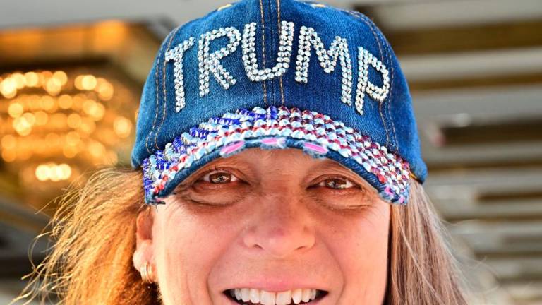 A supporter of Donald Trump wears a bedazzled hat upon leaving Trump International Hotel in Las Vegas, Nevada, on Wednesday. Trump has made it clear that he will introduce tariffs and taxes that will bring manufacturing back to the US. – AFPpic