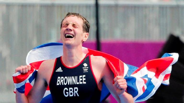 Britain's Alistair Brownlee celebrates after winning in the men's triathlon final during the London 2012 Olympic Games at Hyde Park August 7, 2012. - REUTERSPIX