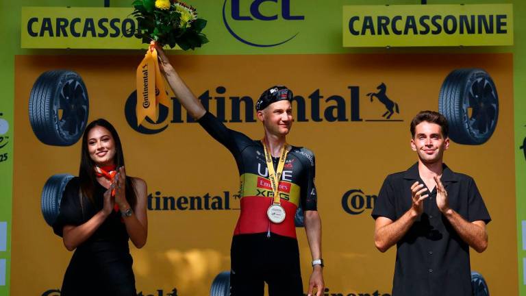 UAE Team Emirates XRG’s Tim Wellens celebrates on the podium after winning stage 15 REUTERS