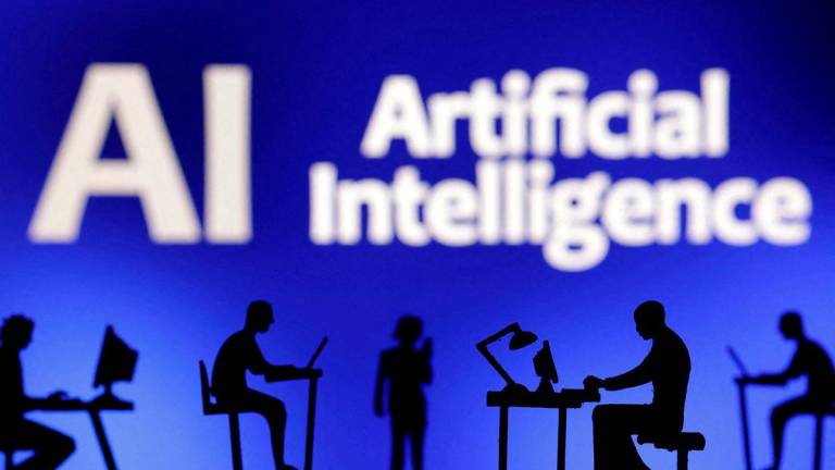 Figurines with computers and smartphones are seen in front of the words “Artificial Intelligence AI” in this illustration taken, February 19, 2024. REUTERSpix