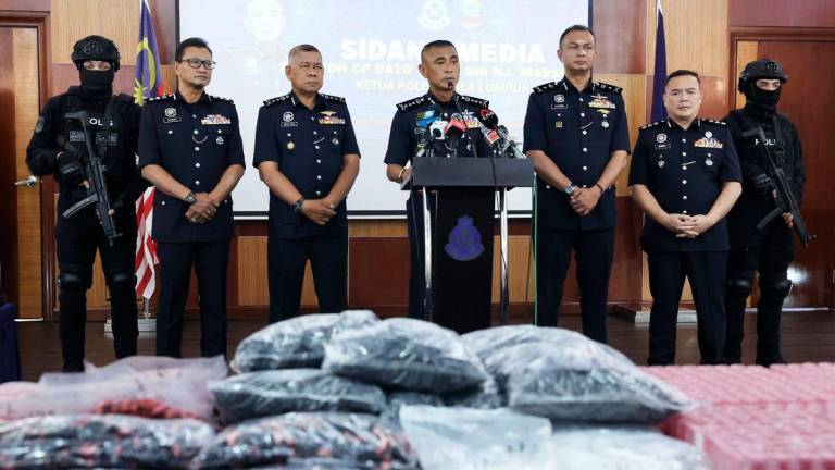 Kuala Lumpur Police Chief Datuk Fadil Marsus (centre) speaks during a press conference today. - BERNAMA