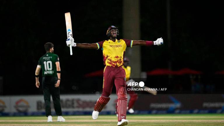West Indies’ Jason Holder raises his arms in celebration after hitting the winning run during the second Twenty20 (T20) international cricket match between West Indies and Pakistan at Central Broward Park &amp; Broward County Stadium in Lauderhill, Florida, on August 2, 2025. (Photo by Chandan Khanna / AFP)