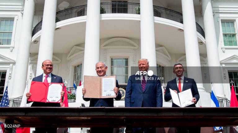 (L-R)Bahrain Foreign Minister Abdullatif al-Zayani, Israeli Prime Minister Benjamin Netanyahu, US President Donald Trump, and UAE Foreign Minister Abdullah bin Zayed Al-Nahyan hold up documents after participating in the signing of the Abraham Accords where the countries of Bahrain and the United Arab Emirates recognize Israel, at the White House in Washington, DC, September 15, 2020. - AFPPIX