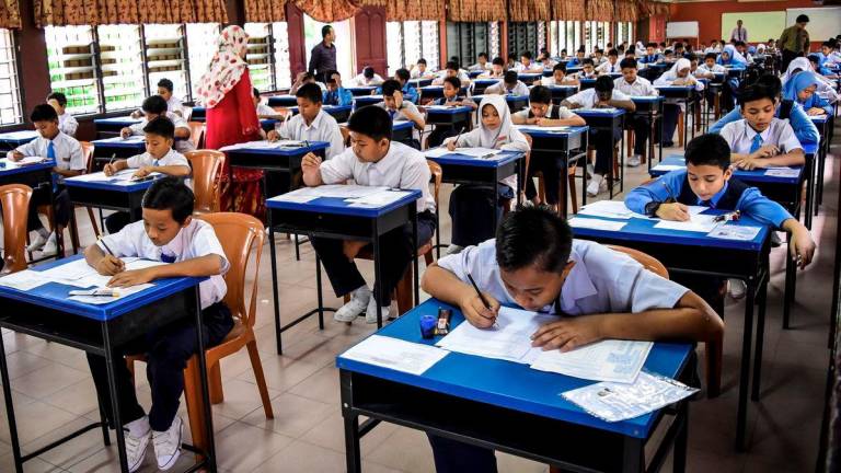 Educators warned lowering passing grade gives children false sense of security, stressing that exams provide milestones that push students to aim higher. – AMIRULSYAFIQ/THESUN
