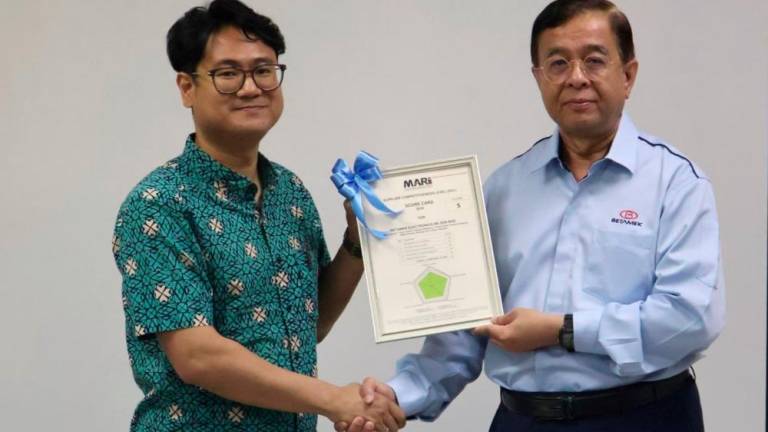 MARii CEO Azrul Reza Aziz presenting the Level 5 SCL certificate to Muhammad Fauzi.