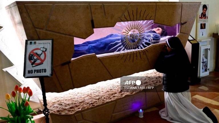 A nun prays at the tomb of Blessed Carlo Acutis, an adolescent who spent his life spreading his faith online, earning the moniker God's Influencer, in the Shrine of the Renunciation in Assisi, part of the Church of Saint Mary Major, on April 3, 2025. - AFP