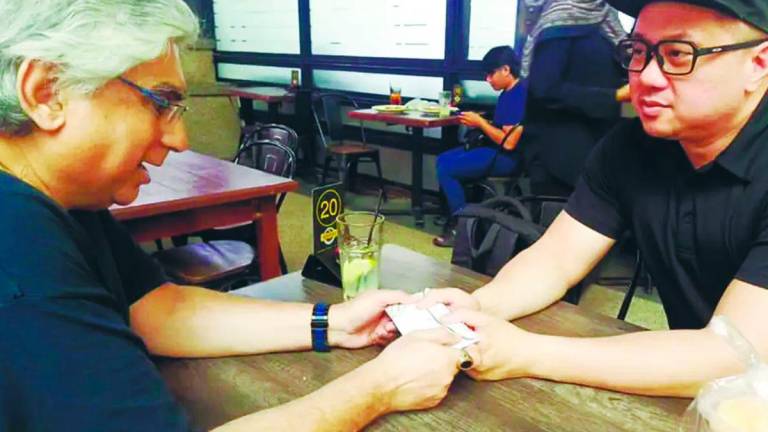 Danny (left) handing over cash to cancer-stricken Chong after the fundraiser last week. – PIC COURTESY OF ICE